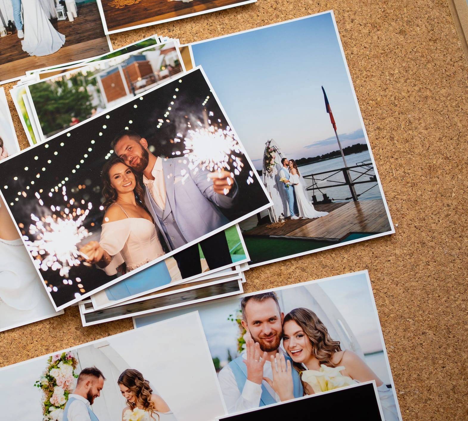 Printed wedding photographs pinned to a cork board, the kind of keepsakes a family keeps safe for good