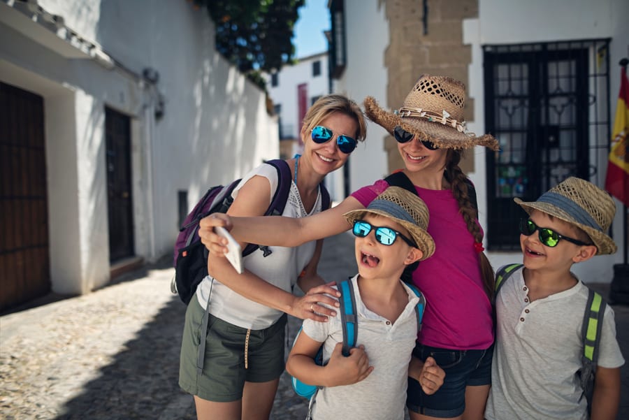 A family taking a selfie in an old town square