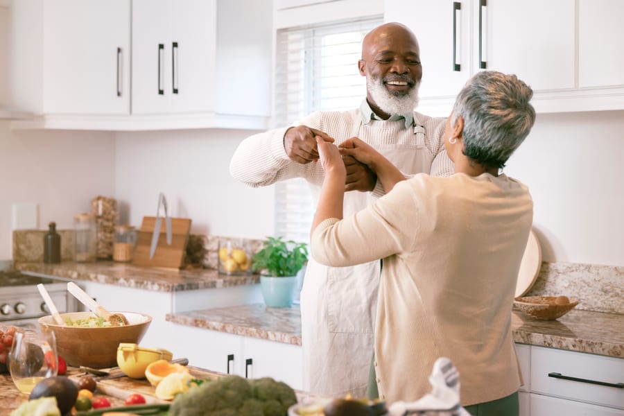 An older couple dancing in their kitchen